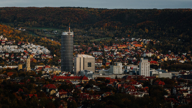 Aerial view of Jena city skyline with Jentower surrounded by colorful autumn forests