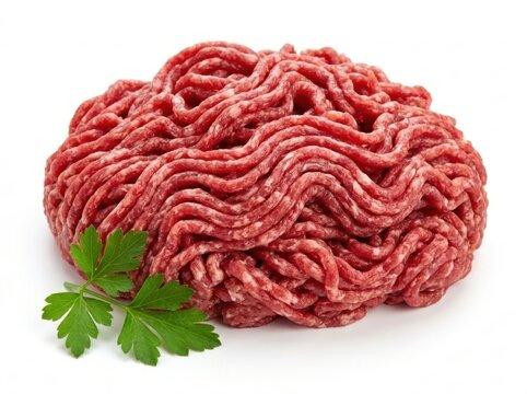 Minced beef meat heap with fresh parsley leaf garnish for culinary burger preparation.