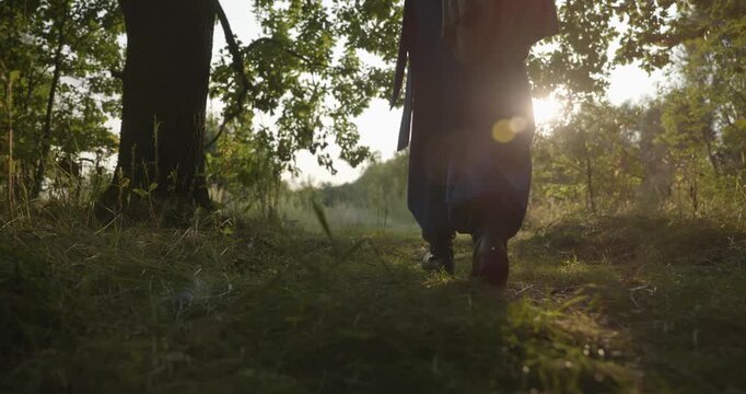 Caucasian man with long hair and Ukrainian traditional folk attire walk wandering on nature. 4K 10-bit