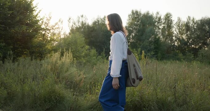 Caucasian man with long hair and Ukrainian traditional folk attire walk wandering on nature. 4K 10-bit