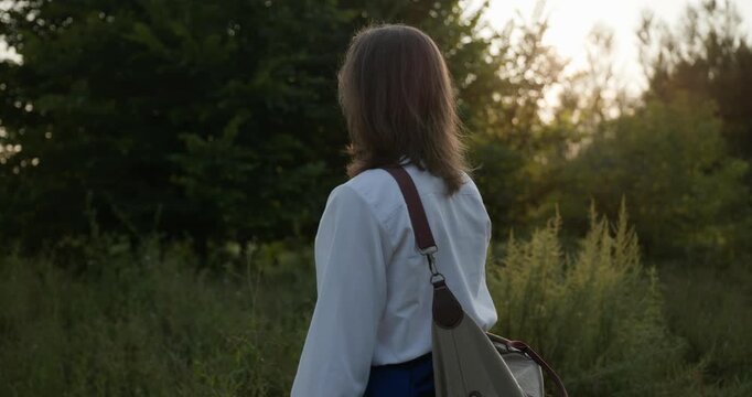 Caucasian man with long hair and Ukrainian traditional folk attire walk wandering on nature. 4K 10-bit