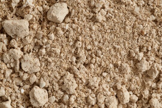 Whole wheat flour and bran creating a coarse textured background, showing organic baking ingredients