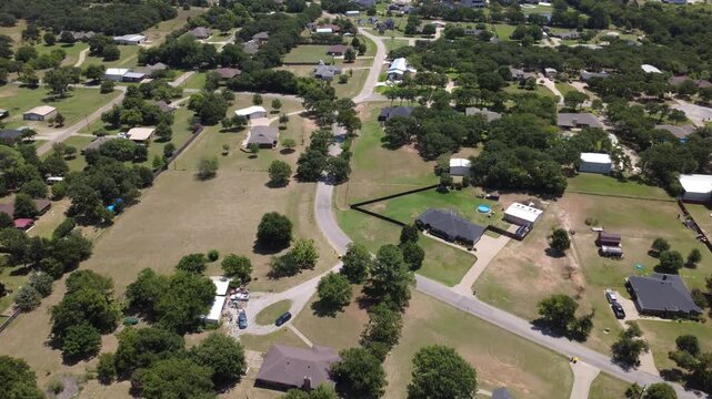 Winding asphalt roads connect residential parcels along Bethesda Road in Dallas Fort Worth. Aerial vantage reveals spacious green lawns, detached workshops, private swimming pools. Burleson, TX
