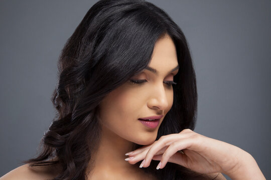 Young female with beautiful hair over colored background 