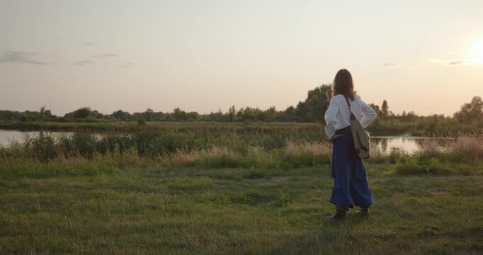 Caucasian man with long hair and Ukrainian traditional folk attire walk wandering on nature. 4K 10-bit