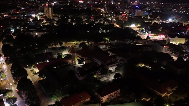 Night Hyperlapse Drone Orbit Around the Bishop's Palace of Buon Ma Thuot Diocese, Illuminated Catholic Religious Architecture and Landmark in Buon Ma Thuot, Dak Lak, Vietnam
