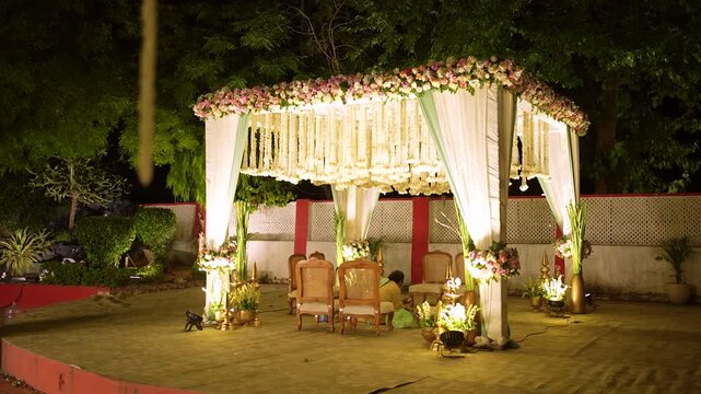 Traditional Indian wedding mandap stage decorated with hanging jasmine flower garlands