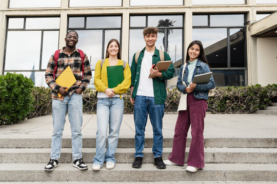 University student friends together in the College campus staircase. Portrait Diversity in global education 