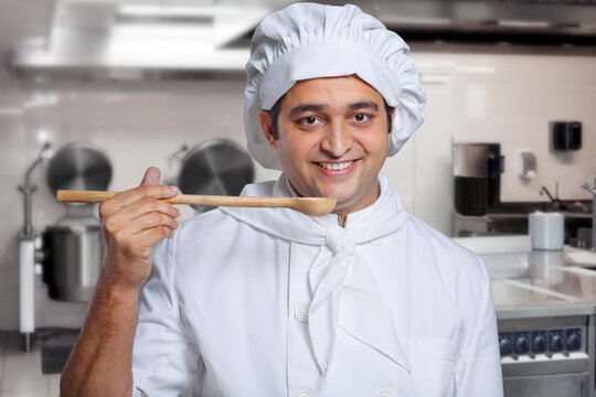 Portrait of a chef with a wooden spoon 