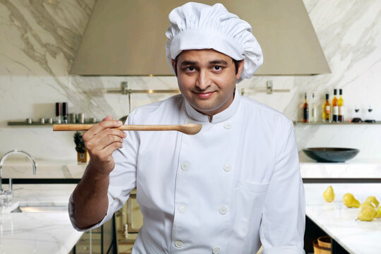 Portrait of a chef with a wooden spoon 