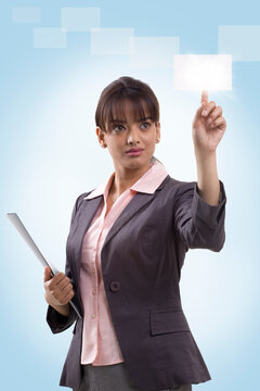 Beautiful young businesswoman using hi-tech computer monitor 