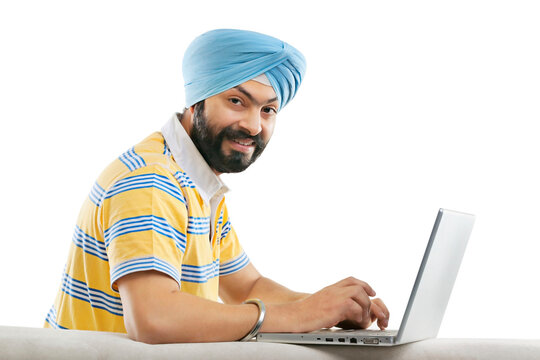 Sikh working on a laptop 