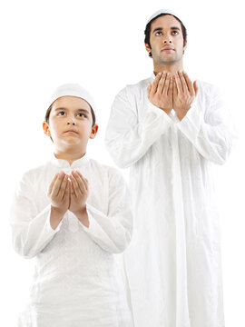 Muslim man and his son doing Namaaz 