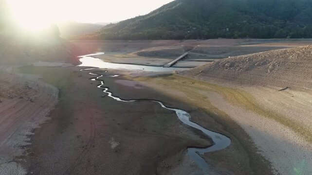 Panoramic view of a dry lake, due to drought in California at sunset.

