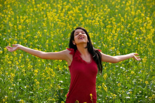 Young woman enjoying herself in a field 