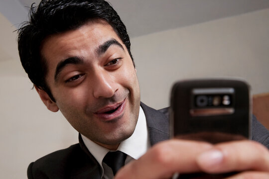 Businessman reading an sms 