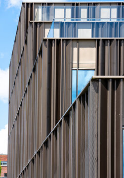 Modern Office Building with Metal Facade and Glass Balconies