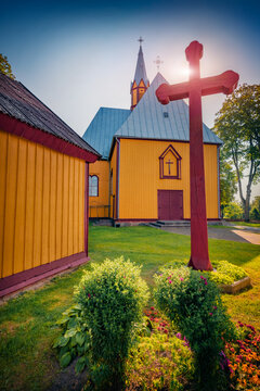 Vertical afternoon view of Catholic Archangel Michael Church. Sunny summer scene of Zemaiciu Naumiestis village, Silute District, Lithuania, Europe. Traveling concept background.