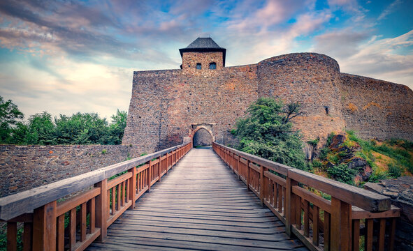 Spectacular summer view of Helfstyn castle - 16th-century, fortified hilltop castle complex, with towers, bastions and courtyards with wooden bridge, Tyn nad Becvou village, Czech Republic.