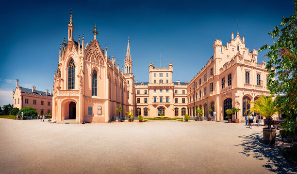 Fabulous afternoon view of Lednice castle, 1800s palace built on a Renaissance chateau and Gothic fort, with a riding hall and formal gardens. Sunny summer cityscape of Lednice town, Czech Republic;.