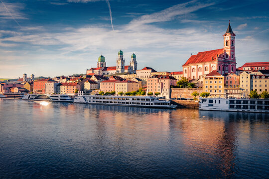 Sunny summer view of Danube river with St. Stephan's Cathedral and St. Paul parish church on background. Splendid morning cityscape of Passau town, Germany, Europe. Traveling concept background.
