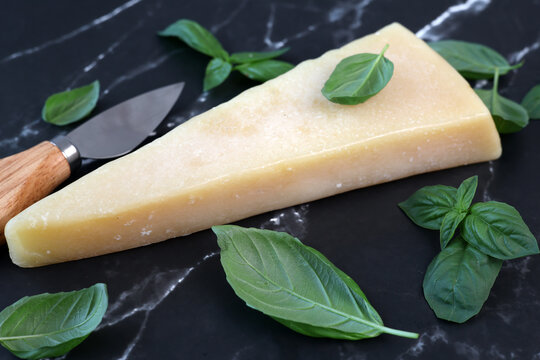 parmesan cheese and basil on black marble