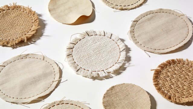 Assortment of round natural fiber coasters arranged on a white surface with eco friendly coasters tableware handmade material decoration circular accessory