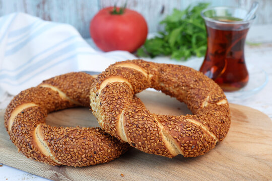 simit bagels on the and and glass of tea	