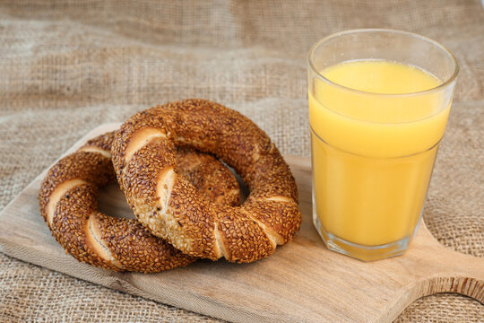 simit bagels on the and and glass of orange juice