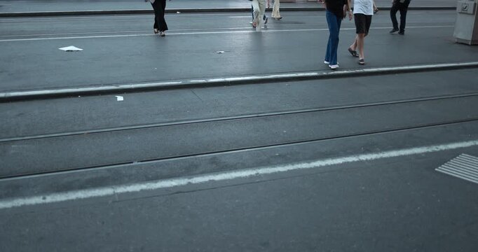 People walking on city street at tram station - Urban lifestyle concept