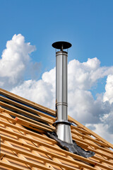 Fototapeta premium Stainless Steel Chimney on a Roof Under Construction