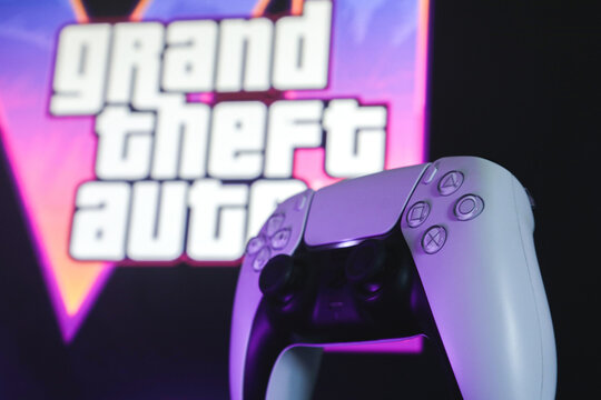 ANTALIA, TURKEY - AUGUST 10, 2026: White PS5 controller in close-up with Rockstar Games Grand Theft Auto 6 (GTA VI) video game title blurred in background.