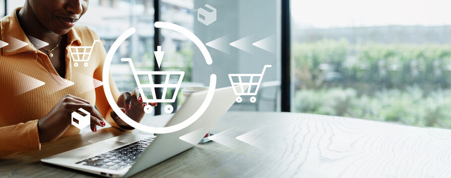 Online shopping at home with a laptop and shopping cart icons on the screen
