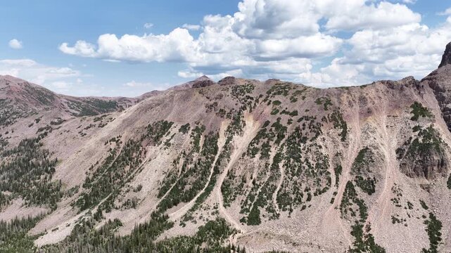 Aerial of Uinta Wasatch Cache National Forest mountain slopes in Utah in summer with steep scree fields against blue sky