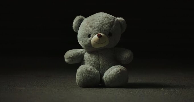 Abandoned, lost and adoption fail with teddy bear in studio for loneliness, depression and grief. Foster care rejection, stuffed animal and mental health with toy on dark background for fear