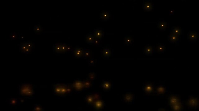Abstract dark background with floating golden fireflies and glowing particles