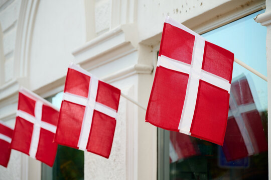 Danish flags on the facade of a building in Copenhagen.