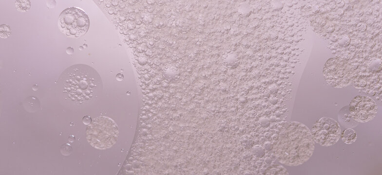 Abstract purple water bubbles essential oil beauty collagen Serum Repair cell background.	