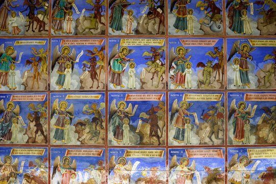 A fresco depicting angels and demons in a religious scene, likely from a church or monastery, with inscriptions in Cyrillic script.