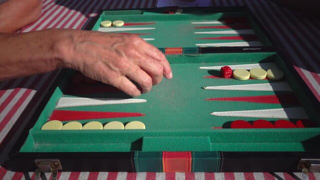 Hirtshals, Denmark Two people playing backgammon while rolling dice. 