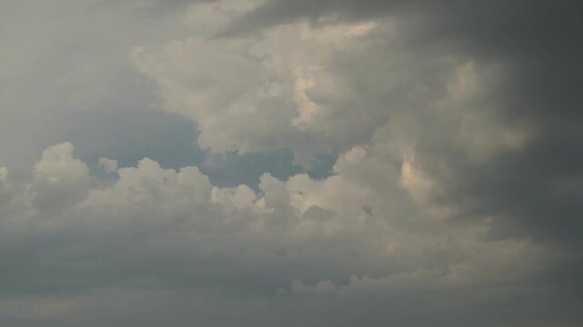 timelapse of contrasting white and dark clouds in sky