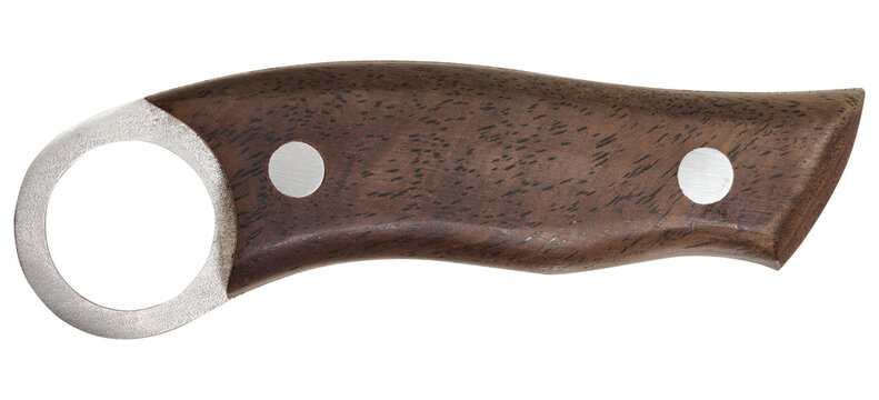 Isolated close-up view of a karambit knife handle with dark wood texture and metal finger ring