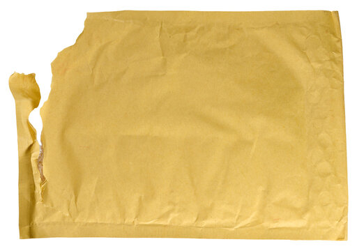 Torn yellow paper mailing envelope with bubble wrap on isolated background.