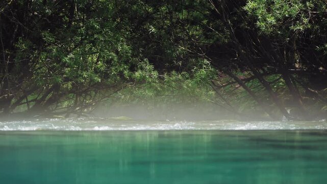 View of the striking turquoise water of Oko Skakavice, known as The Eye, a crystal-clear karst spring surrounded by pristine nature near Gusinje, Montenegro.