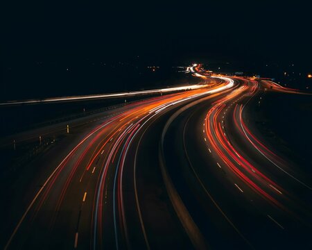 Long exposure highway at night, light trails, urban commute, city traffic, speed, motion blur, dark background for design.