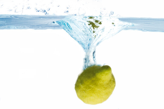 Lemon splashing into water