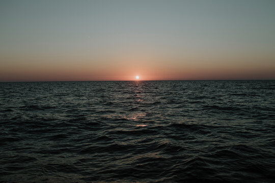 The sun sets over the Mediterranean sea during a sailing vacation
