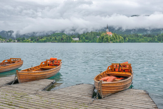 Wooden rowboats line the dock at Lake Bled in Slovenia