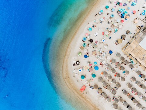 Drone captures an aerial view of a tropical beach with turquoise sea