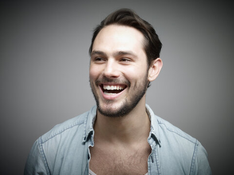 Young man looking away, smiling